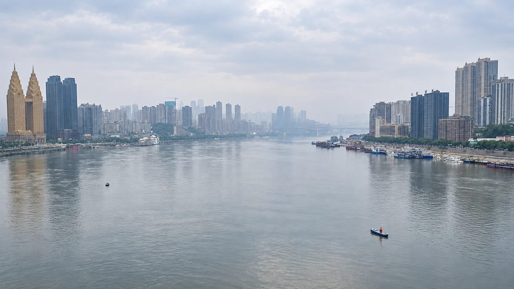 The Yangtze River and south-bank waterfront in misty daylight